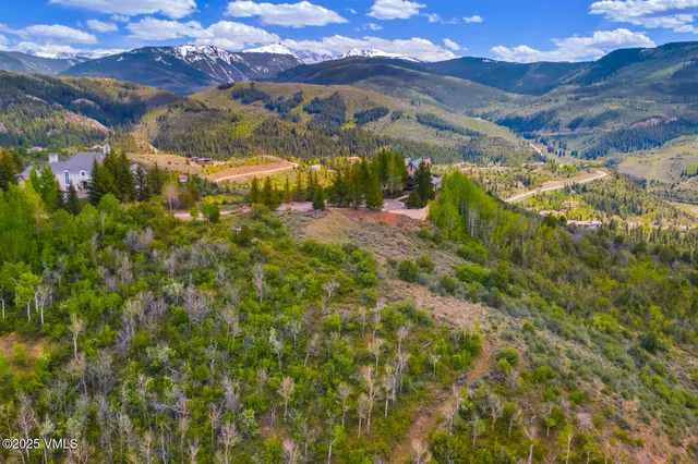 a view of a white house with a snow on the road