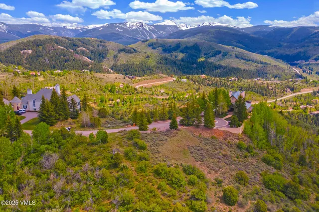 a view of a snow with the view of mountains