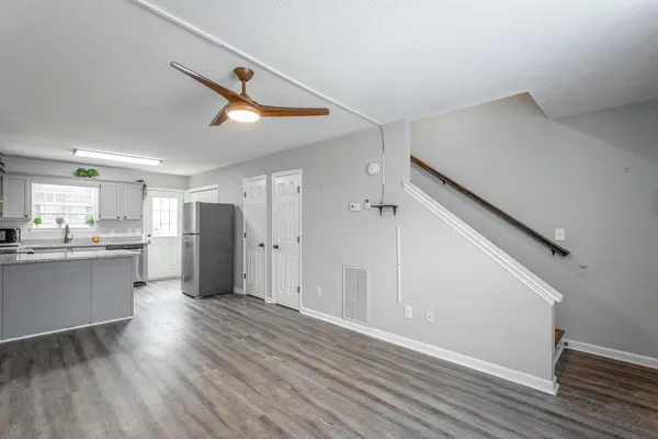 a view of large kitchen with wooden floor and electronic appliances