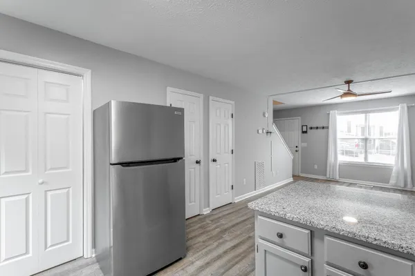 a kitchen with a refrigerator and a stove top oven