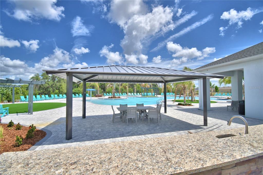 2839 Moulin Road Davenport, FL 33837 - Photo 72 of 75 a view of a patio with a table chairs and a patio