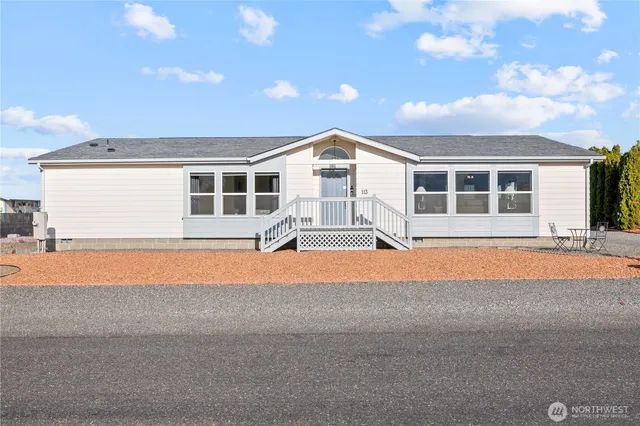 a front view of a house with a yard and a garage