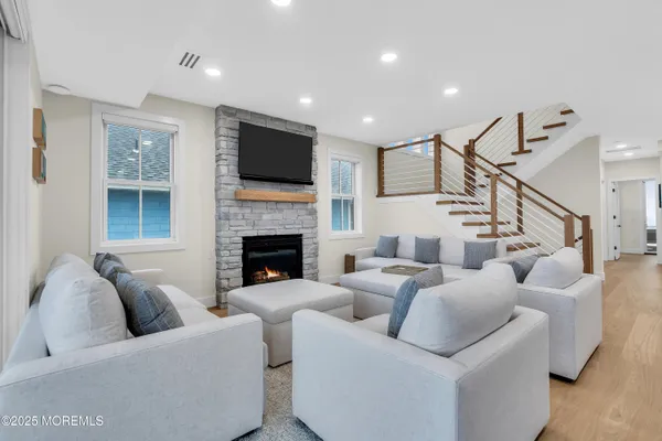 a living room with furniture fireplace and flat screen tv