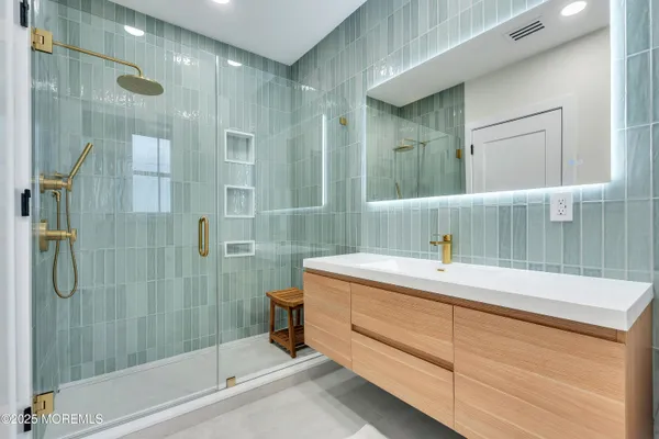a bathroom with a granite countertop sink a toilet and shower