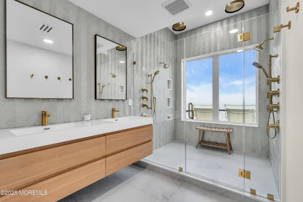 a bathroom with a sink a toilet and a large mirror