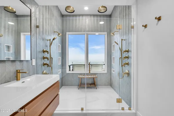 a large white kitchen with a large window and stainless steel appliances