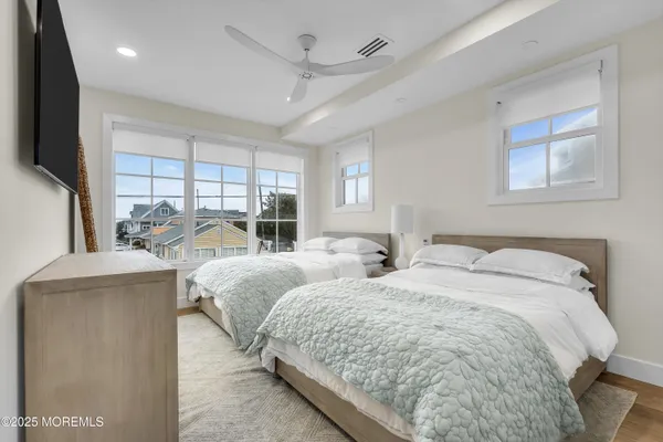 a bedroom with a bed and a potted plant