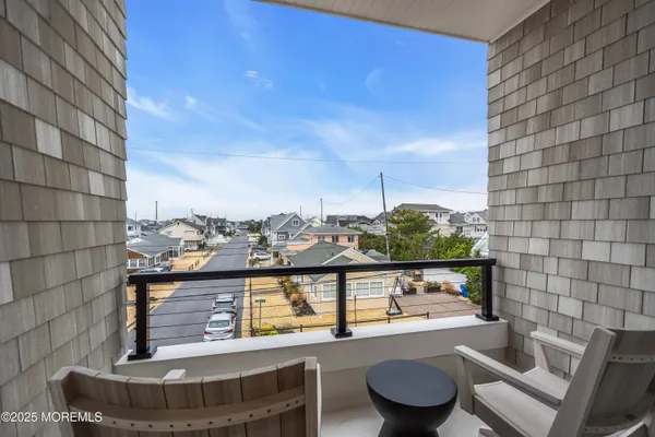 a view of a chairs and table on the roof deck