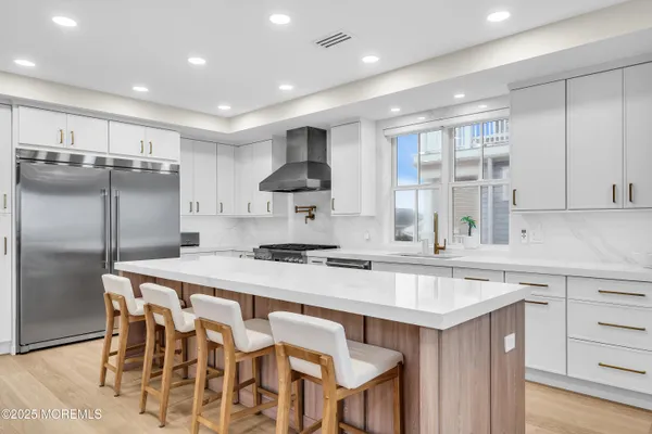 a kitchen with granite countertop a sink and stainless steel appliances