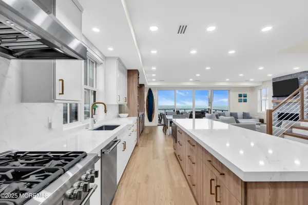 a large kitchen with stainless steel appliances lots of counter space and a sink