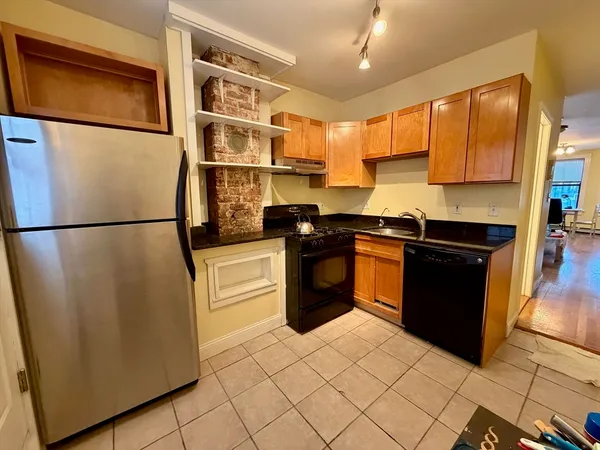 a kitchen with stainless steel appliances granite countertop a refrigerator a sink and a stove