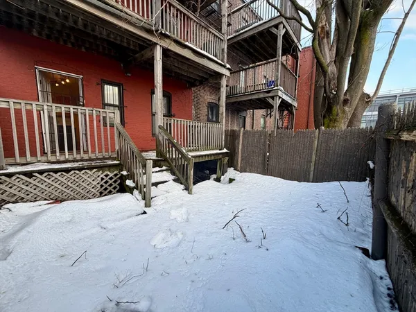 a view of a house with a wooden fence