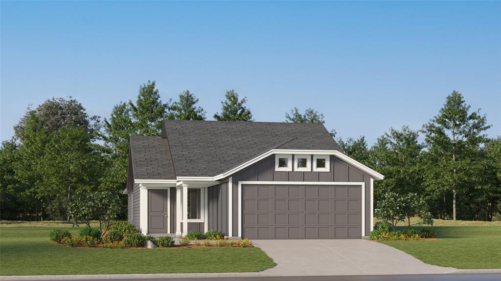 a front view of a house with a yard and trees