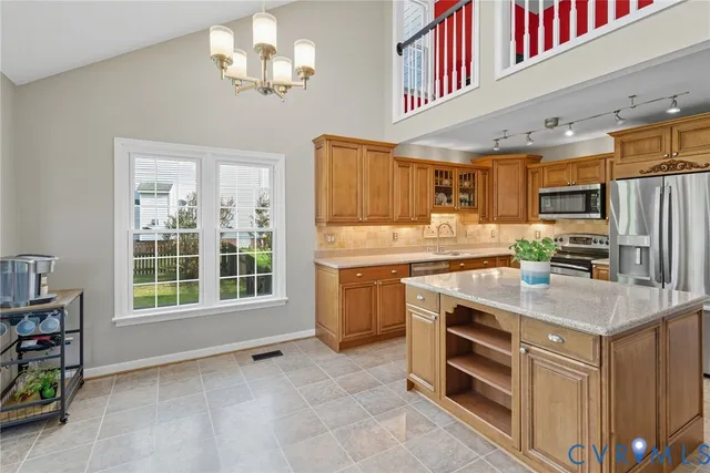 a kitchen with stainless steel appliances a stove microwave and cabinets