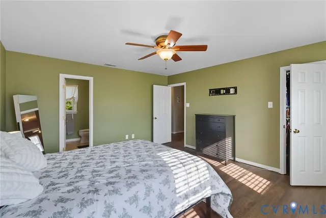 a bathroom with a granite countertop sink a toilet a mirror a vanity and shower