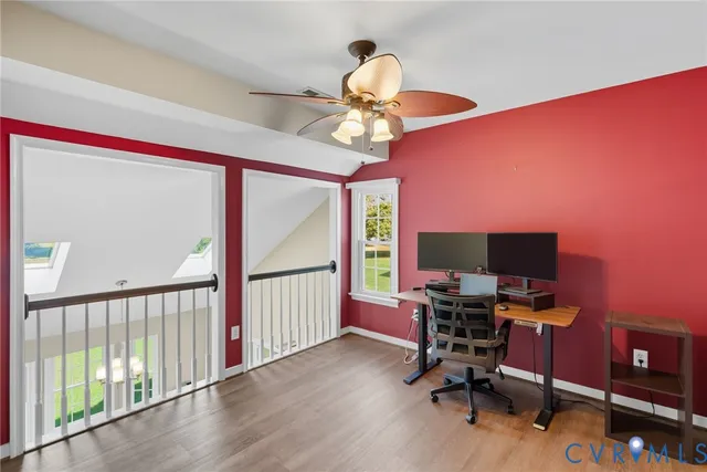 a view of a workspace with furniture and a window