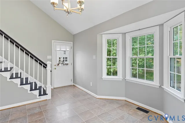 a view of an entryway with wooden floor and windows