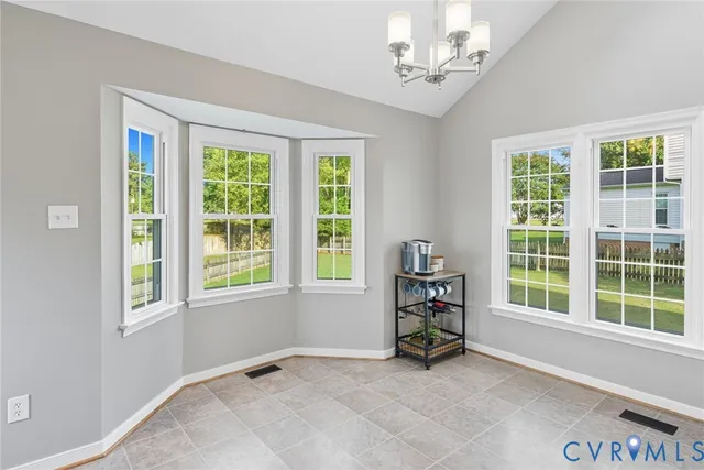 a kitchen with kitchen island granite countertop a sink window and refrigerator