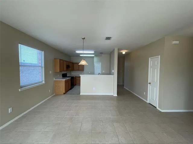 a view of a kitchen with a sink and a refrigerator