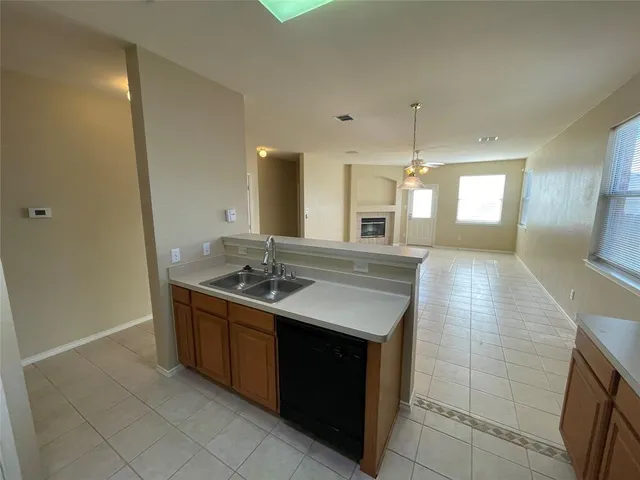 a kitchen with stainless steel appliances a sink stove and cabinets