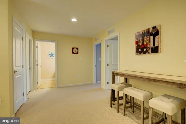 a view of a room with shelves and wooden floor