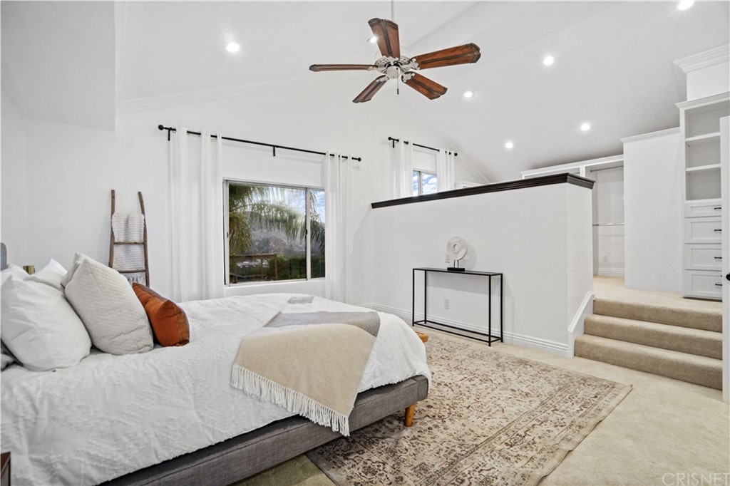 24609 Skyridge Drive Newhall, CA 91321 - Photo 25 of 60 a bedroom with a large bed and a chandelier