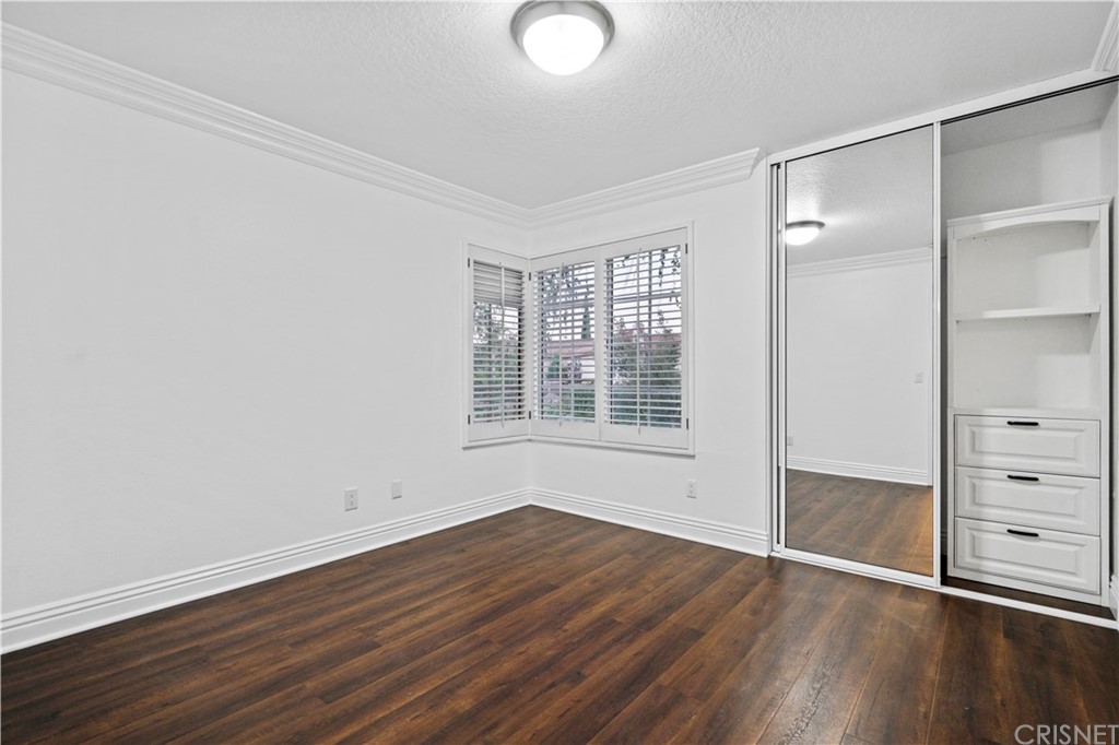 24609 Skyridge Drive Newhall, CA 91321 - Photo 33 of 60 an empty room with wooden floor and windows