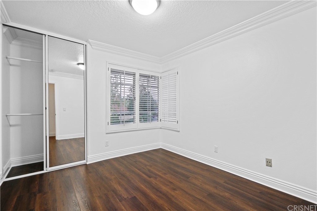 24609 Skyridge Drive Newhall, CA 91321 - Photo 34 of 60 an empty room with wooden floor and a window