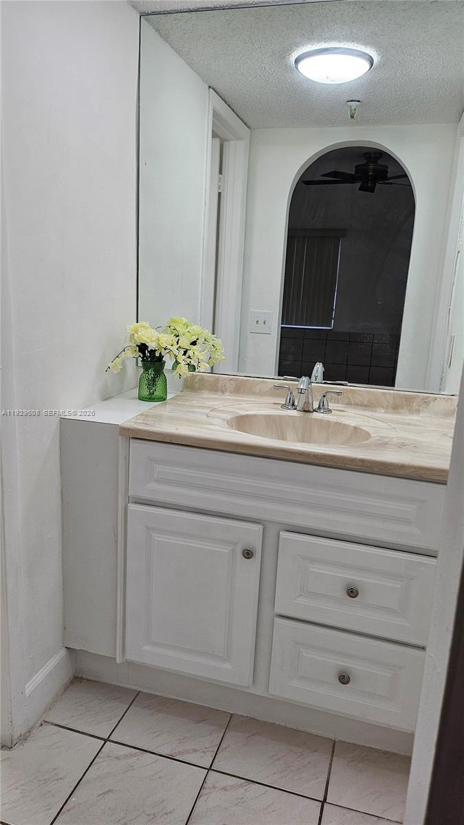 10641 Southwest 108th Avenue, Unit 1H Miami, FL 33176 - Photo 15 of 22 a bathroom with a sink and a mirror