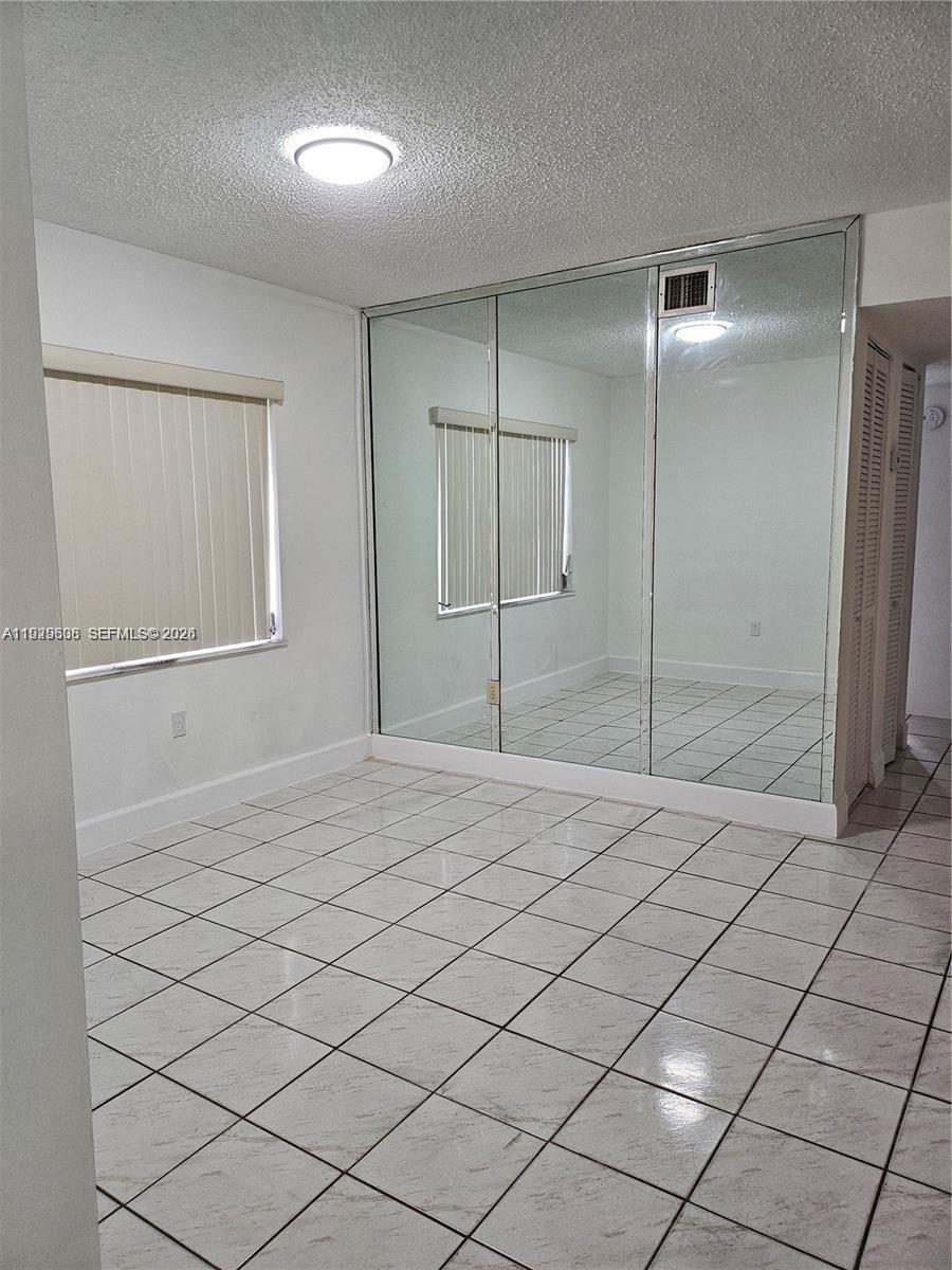 10641 Southwest 108th Avenue, Unit 1H Miami, FL 33176 - Photo 5 of 22 a bathroom with a sink and a shower