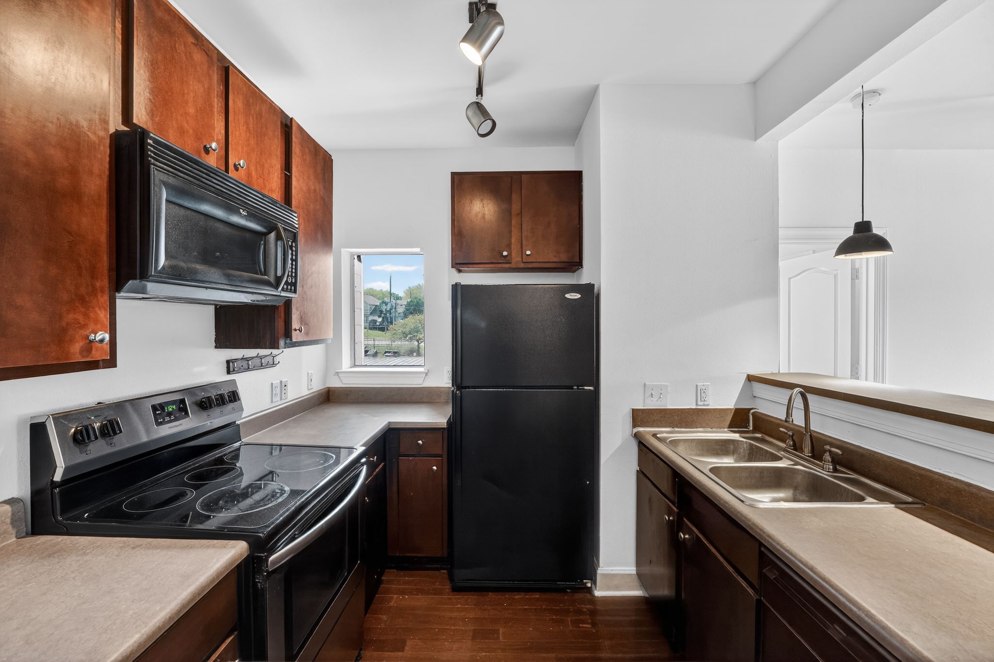 a kitchen with a sink stove and refrigerator