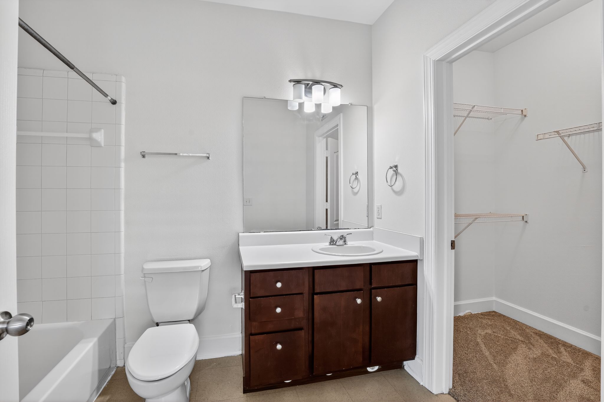 1901 Crossing Place, Unit 2201A Austin, TX 78741 - Photo 18 of 23 a spacious bathroom with a toilet a sink and a mirror