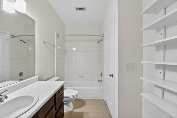 a bathroom with a sink toilet vanity and shower