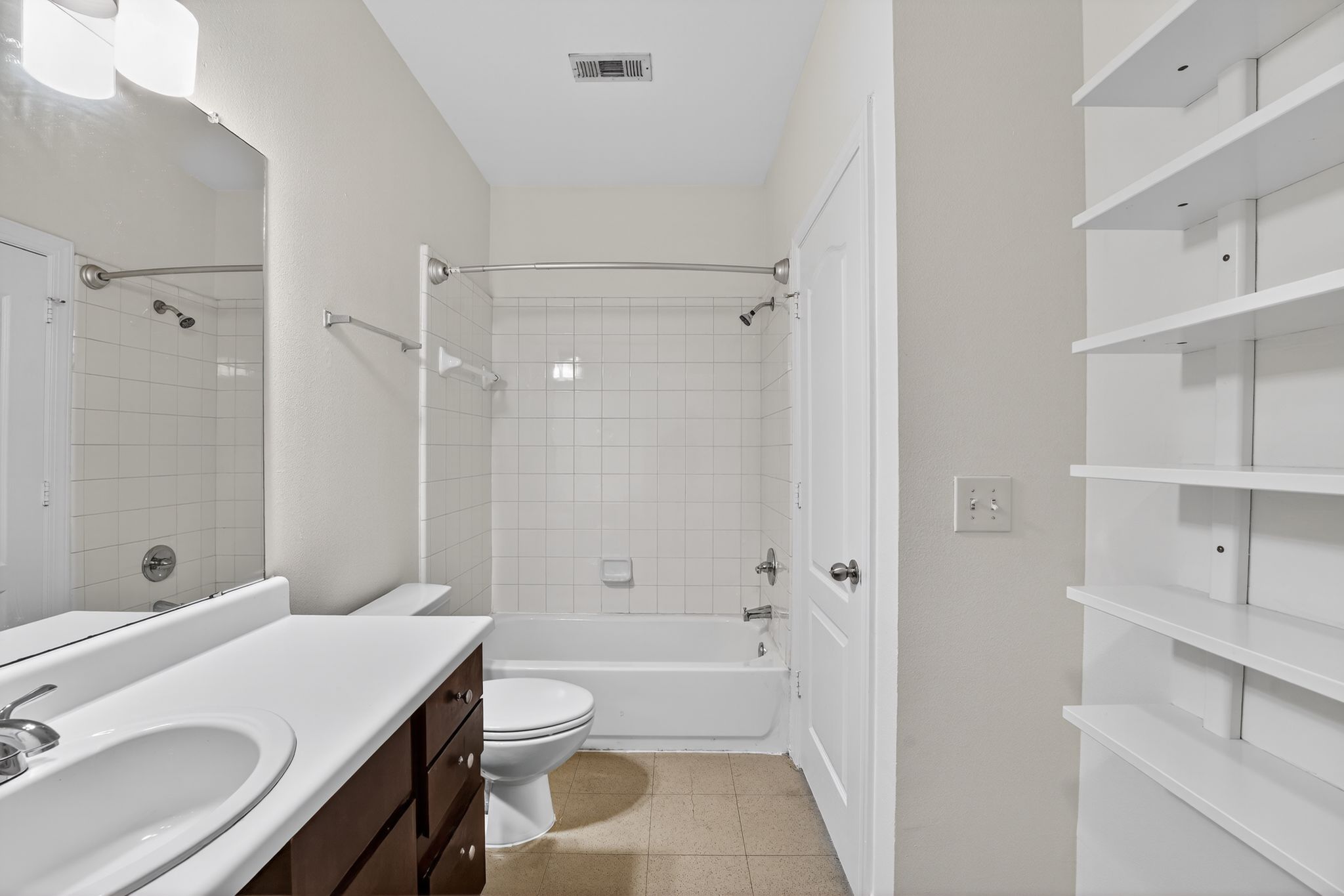 1901 Crossing Place, Unit 2201A Austin, TX 78741 - Photo 19 of 23 a bathroom with a sink toilet vanity and shower