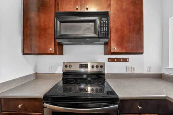 a stove top oven sitting inside of a kitchen