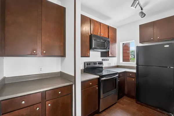 a kitchen with stainless steel appliances a refrigerator stove and sink
