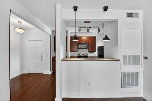 a kitchen with stainless steel appliances granite countertop a refrigerator a sink and a stove