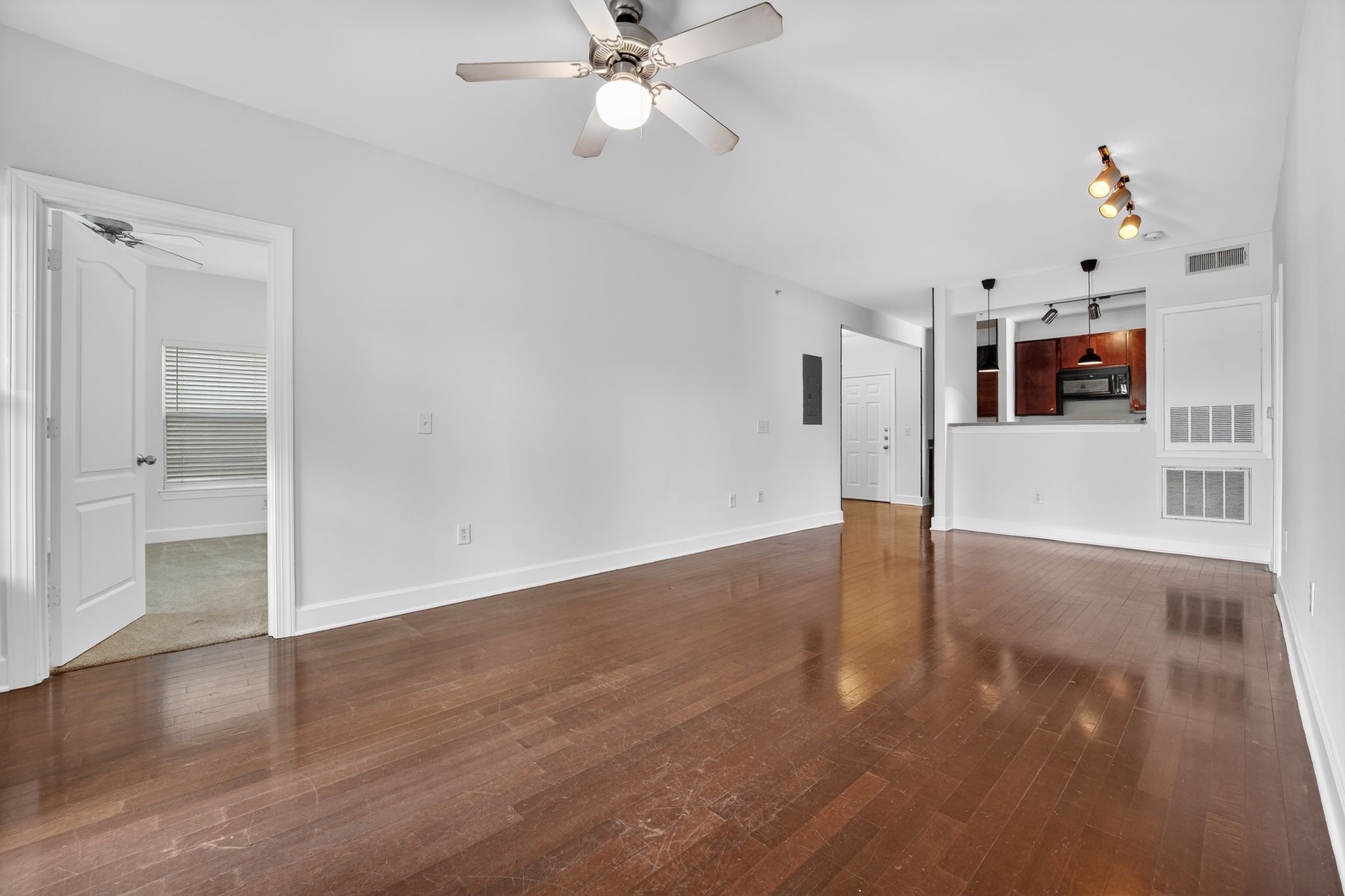 1901 Crossing Place, Unit 2201A Austin, TX 78741 - Photo 9 of 23 a view of a livingroom with wooden floor and a ceiling fan