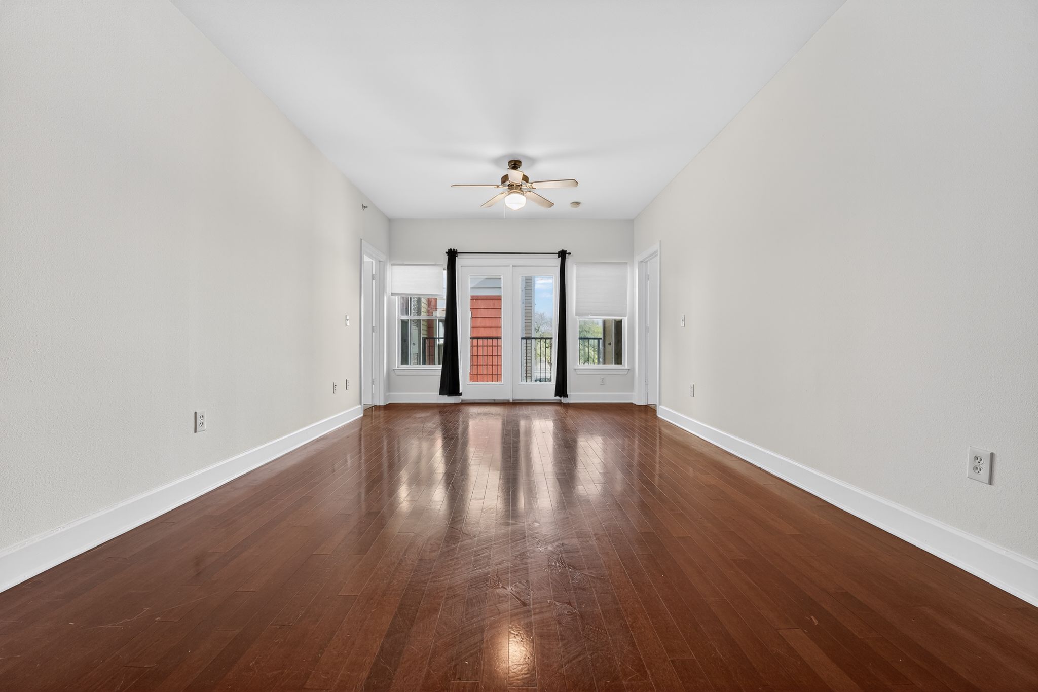 1901 Crossing Place, Unit 2201A Austin, TX 78741 - Photo 10 of 23 an empty room with wooden floor and windows
