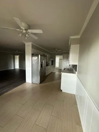 a view of a kitchen with a sink and a window