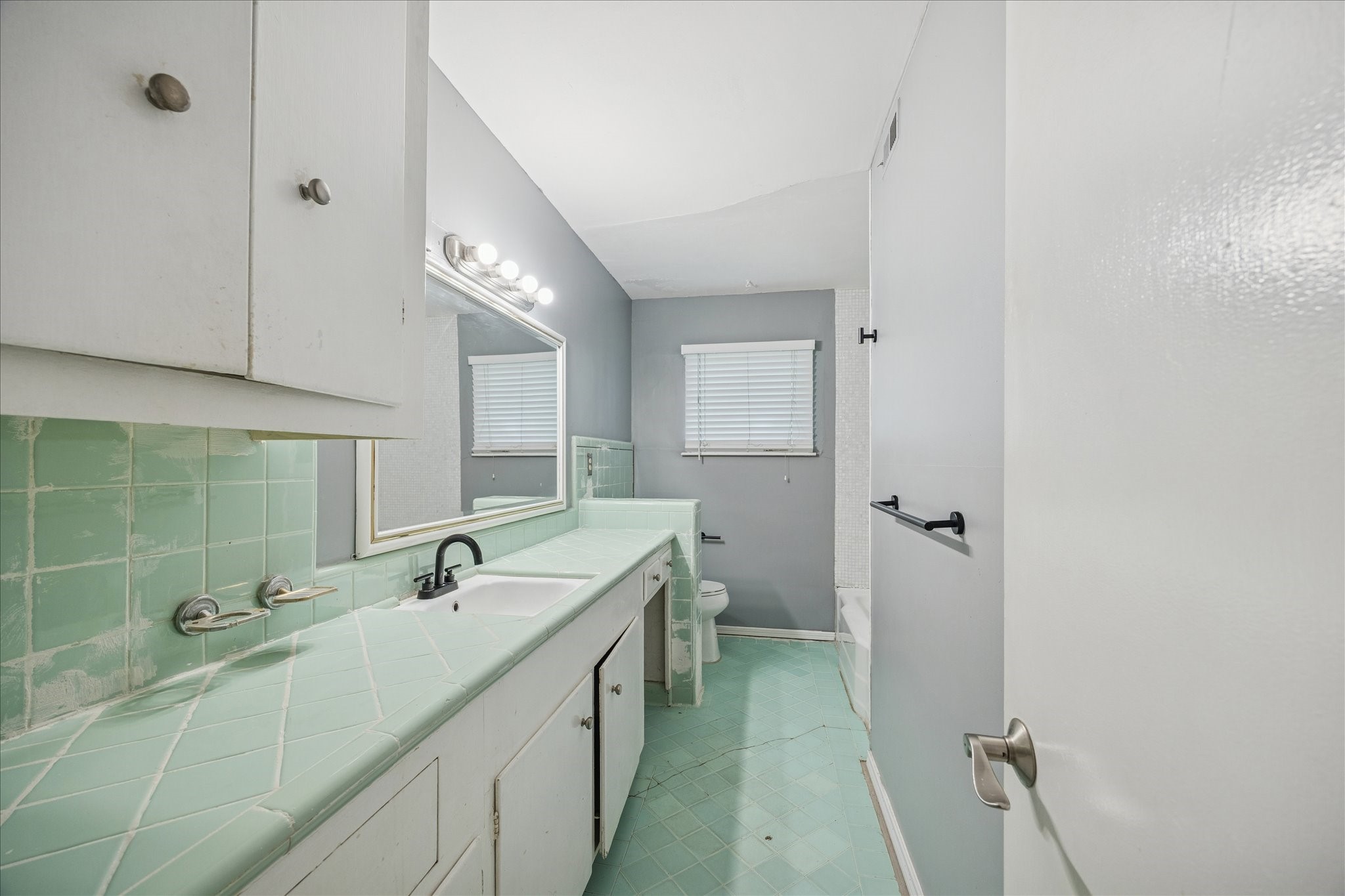 8419 Bluegate Court Houston, TX 77025 - Photo 11 of 12 a bathroom with a double vanity sink and mirror