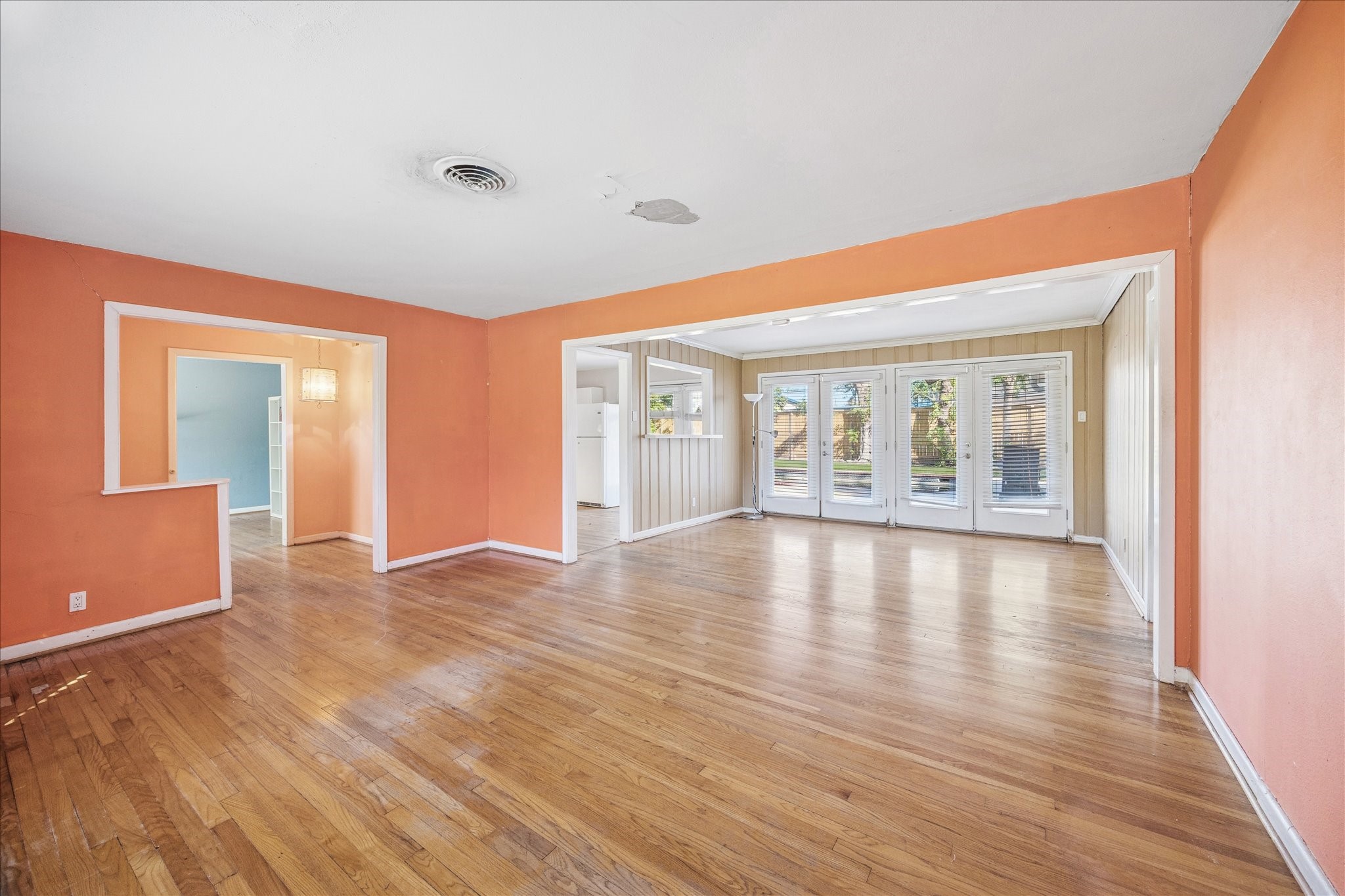 8419 Bluegate Court Houston, TX 77025 - Photo 2 of 12 a view of an empty room with wooden floor and a window