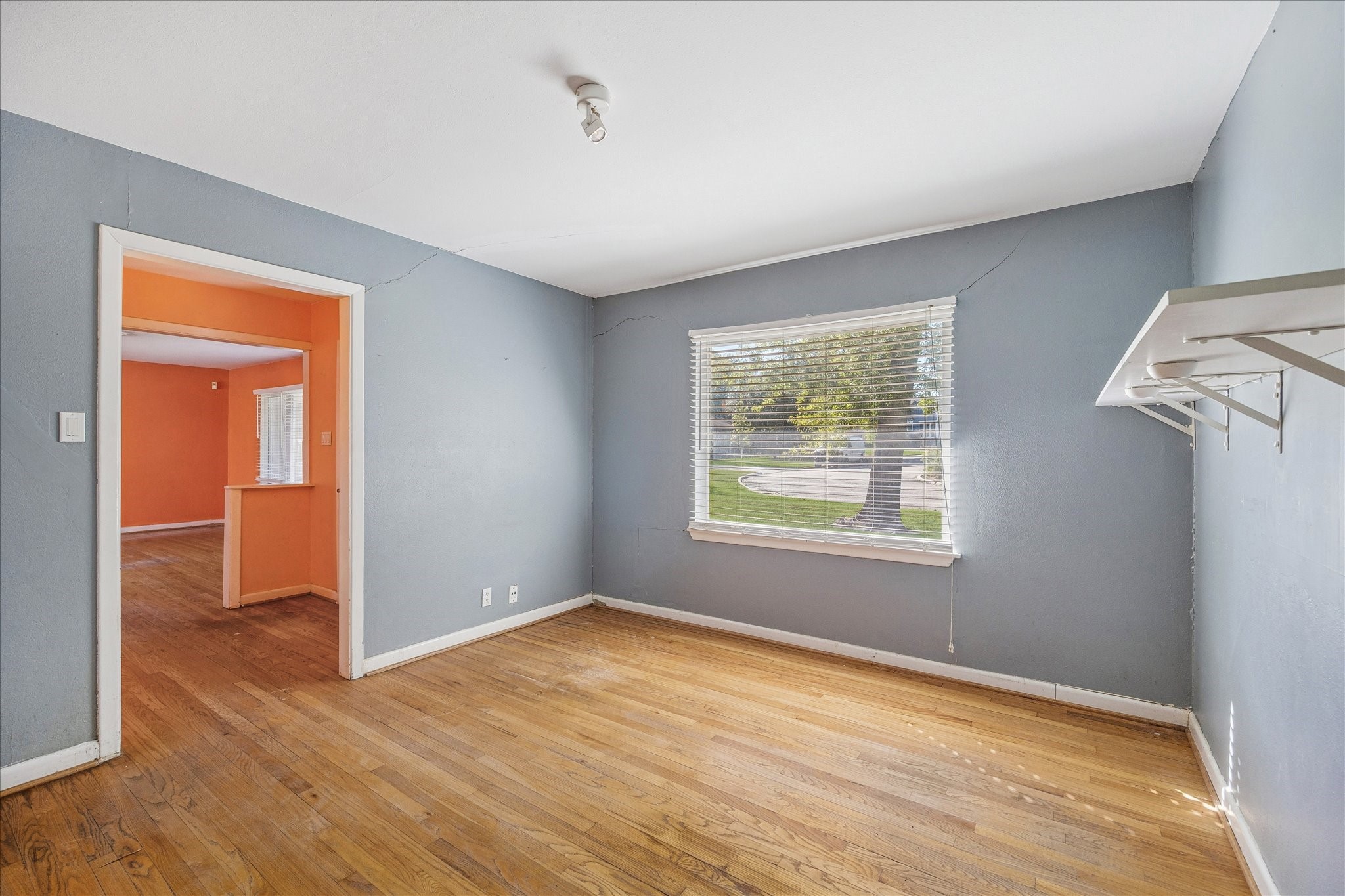 8419 Bluegate Court Houston, TX 77025 - Photo 6 of 12 a view of empty room with wooden floor and fan
