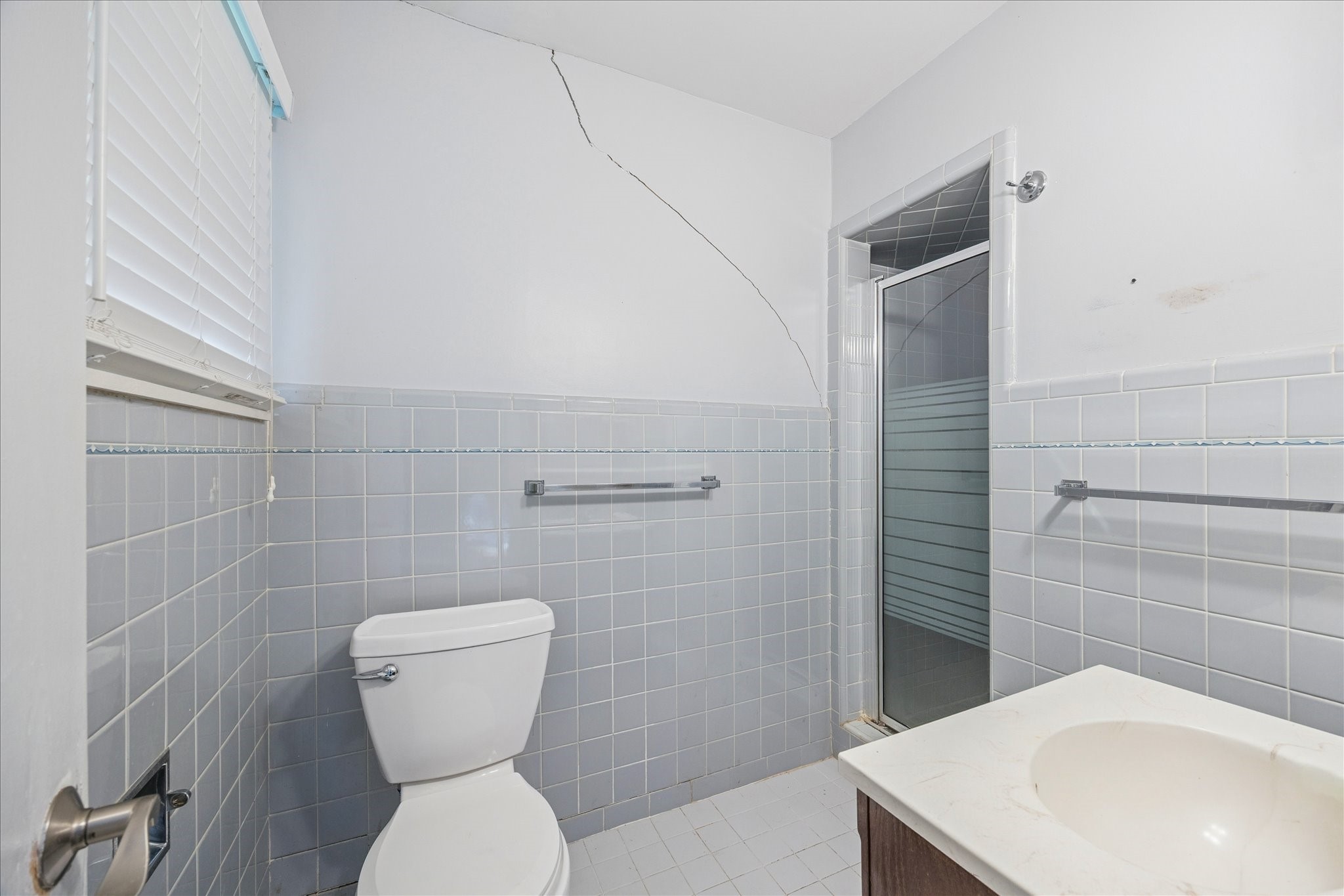 8419 Bluegate Court Houston, TX 77025 - Photo 8 of 12 a bathroom with a toilet sink and shower