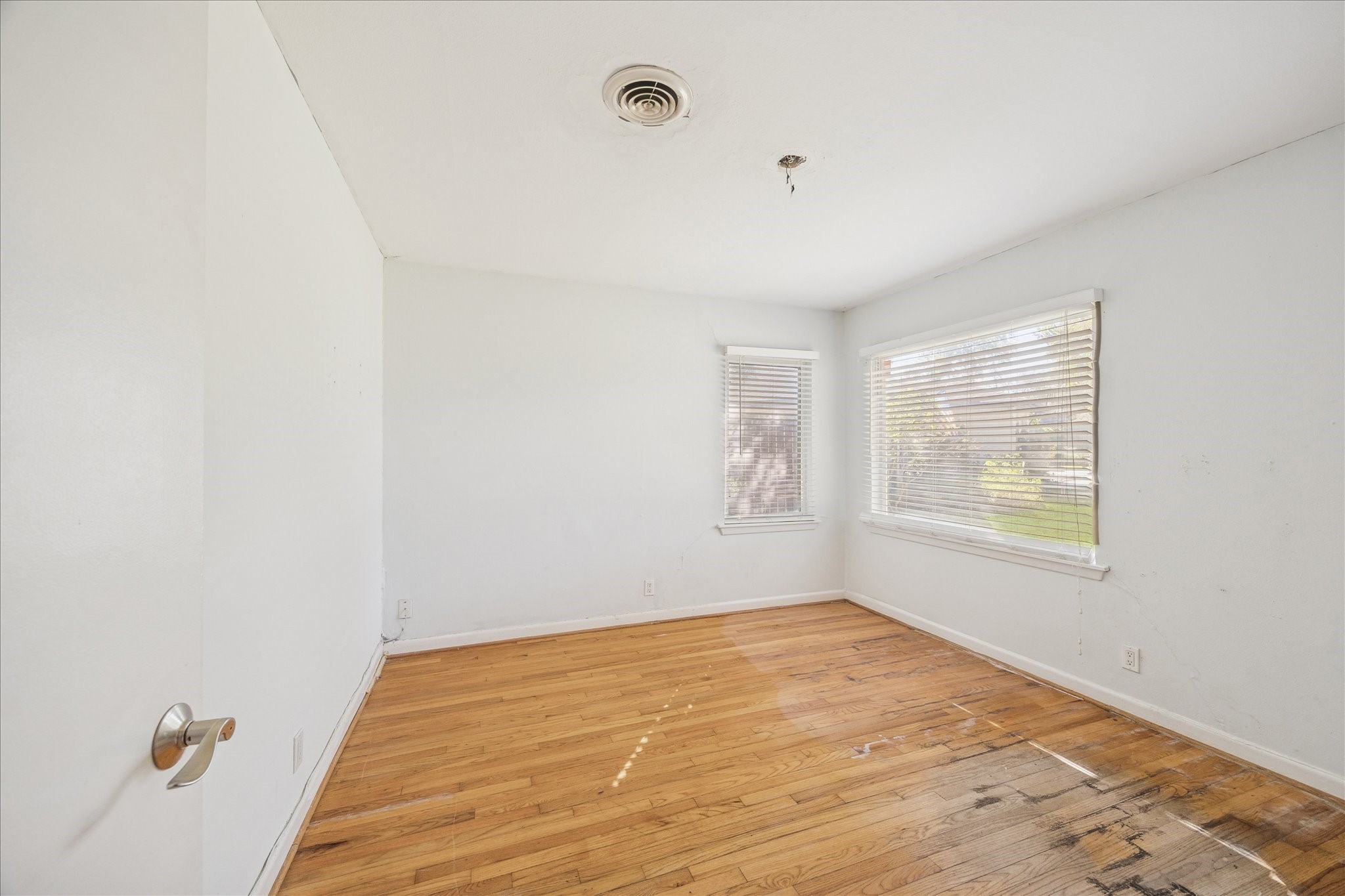 8419 Bluegate Court Houston, TX 77025 - Photo 10 of 12 a view of an empty room with wooden floor and a window