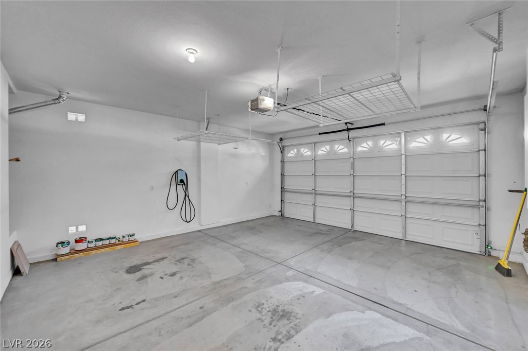 977 Sparkling Light Street Henderson, NV 89052 - Photo 65 of 75 This spacious garage offers convenience with an electric vehicle charging station and overhead storage.