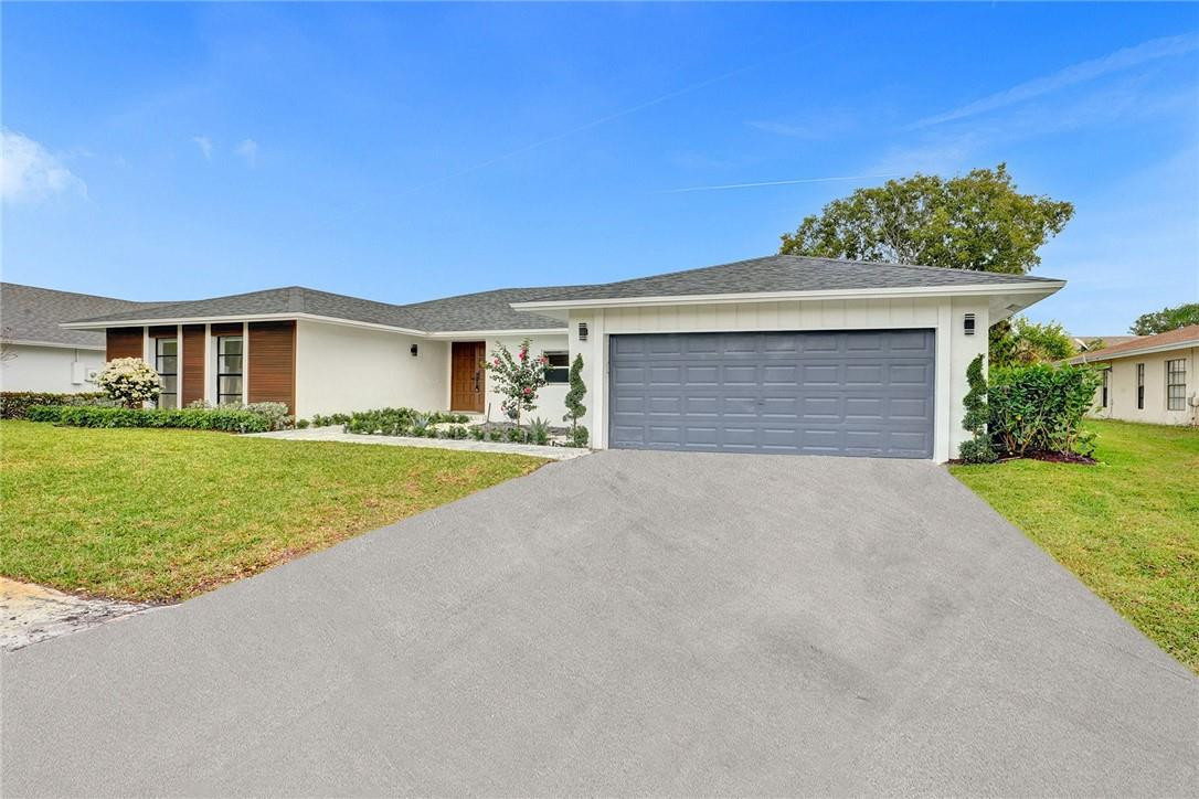 17702 Raintree Terrace Boca Raton, FL 33487 - Photo 25 of 67 a view of house with outdoor space and garden