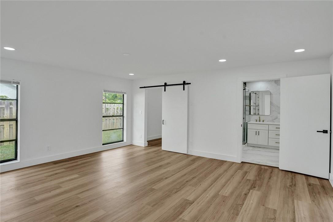 17702 Raintree Terrace Boca Raton, FL 33487 - Photo 47 of 67 an empty room with wooden floor and windows