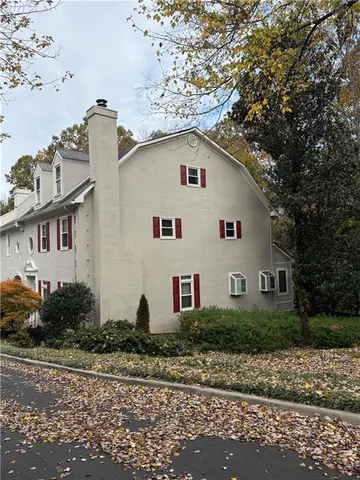 a view of a white house with a yard