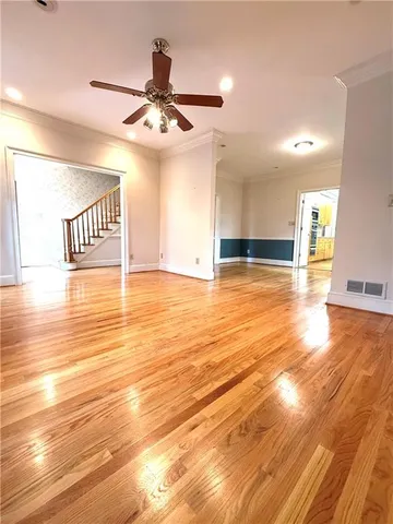 a view of a room with wooden floor